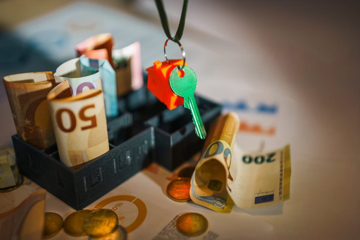 House key and euro bills depicting real estate and financial themes.